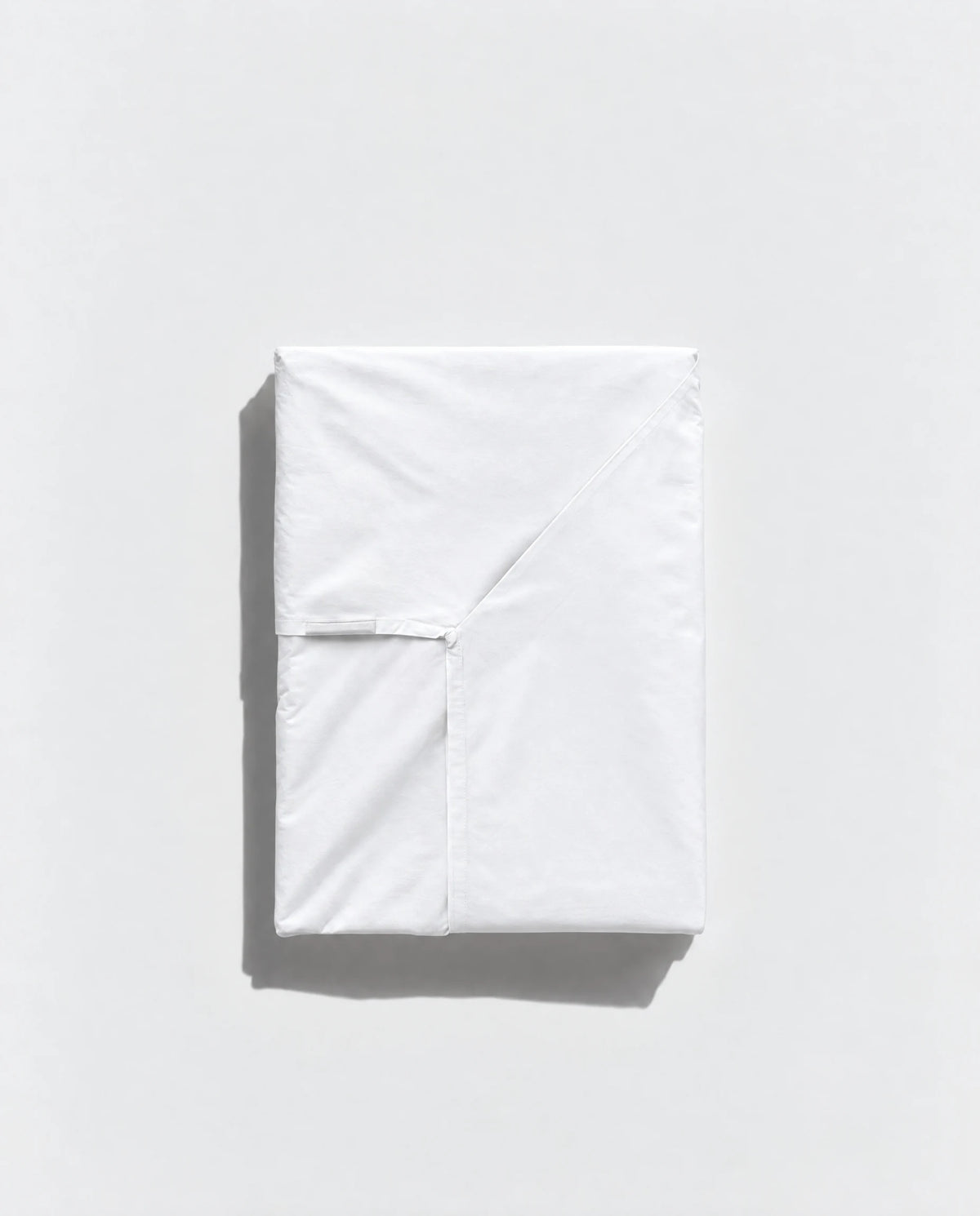 Folded white Geismars envelope sheet showing its opening on a pale grey background